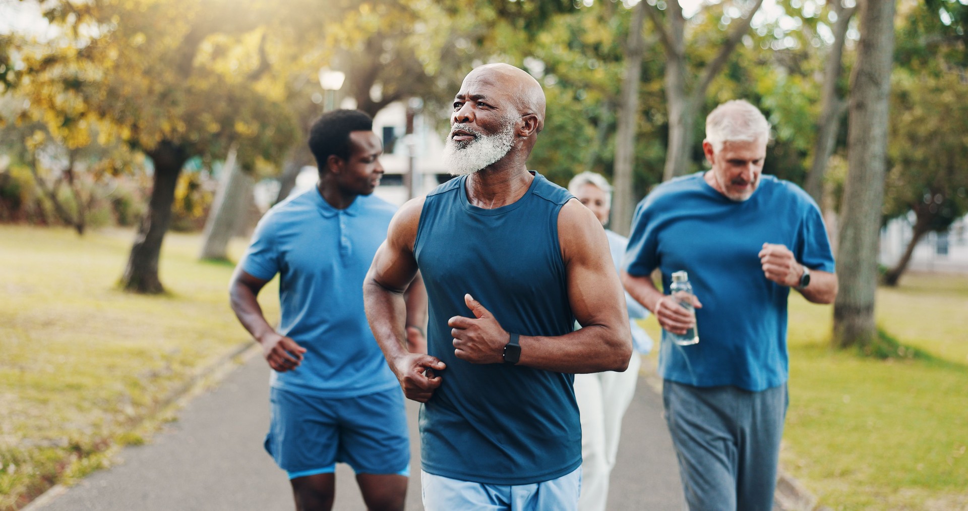 Senior, people and running for fitness outdoor of mobility training, exercise and morning routine. Elderly, community and coach for wellness, cardio support and retirement workout of health at park